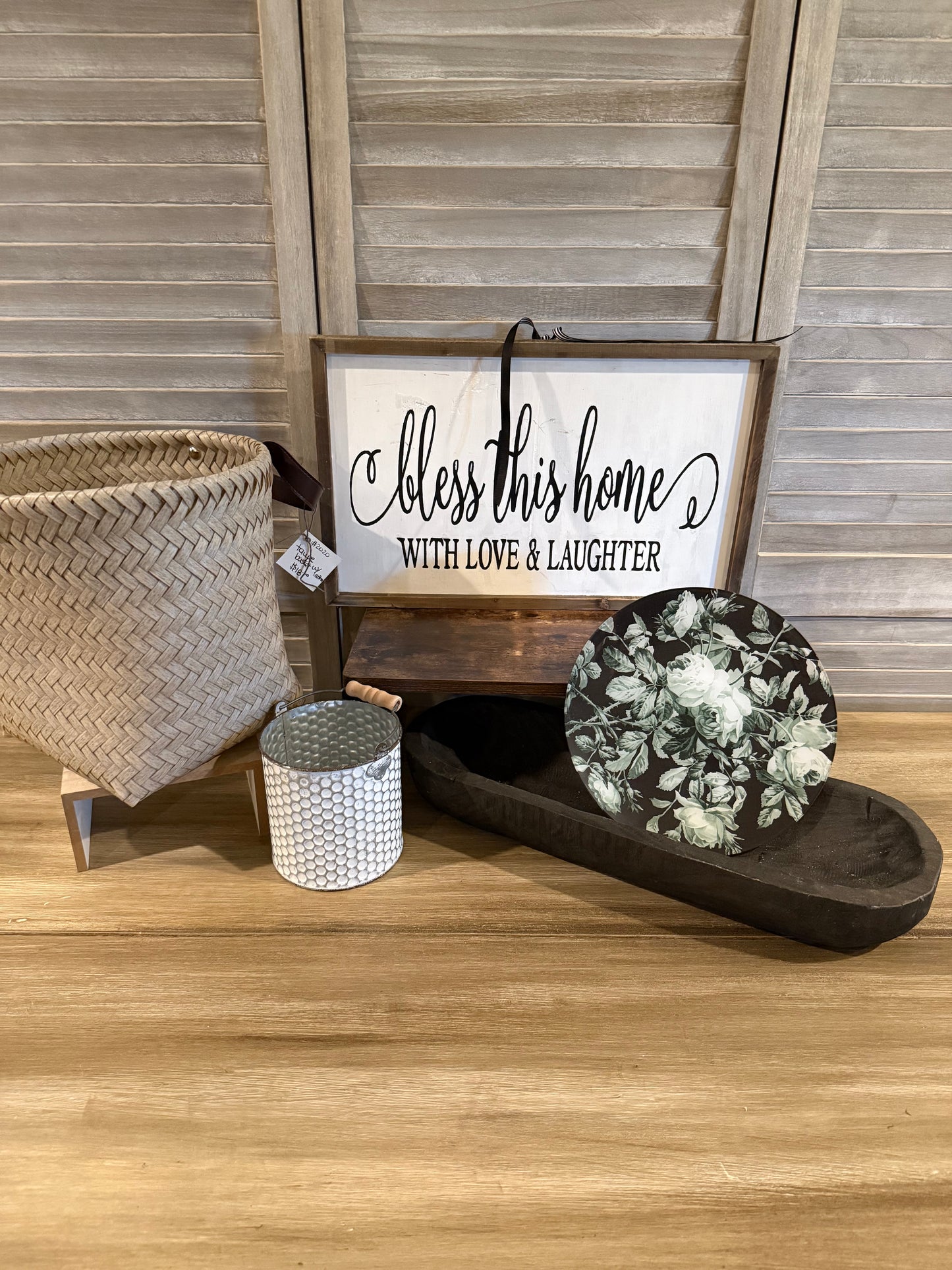 Farmhouse décor bundle with 'Bless This Home' sign, woven basket, white metal bucket, black dough bowl, and floral accent plate—perfect for rustic home styling